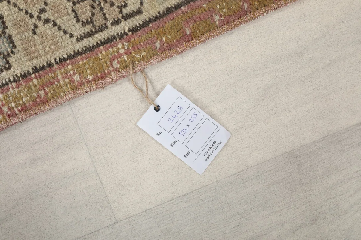 Product tag displaying the rug's size and origin on a light wooden floor