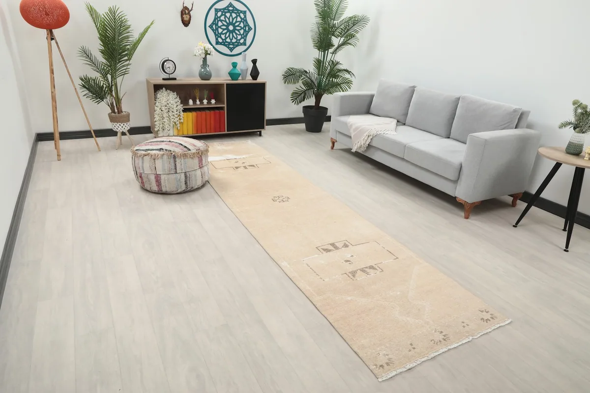 Overhead view of the beige Anatolian runner rug in a living room, showing its placement relative to furniture