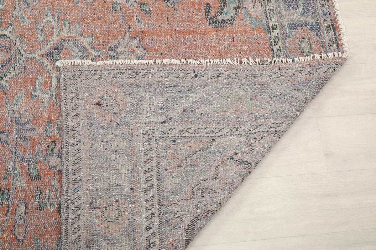 Close-up of the rug's reverse side, showing the intricate knotting and foundation.