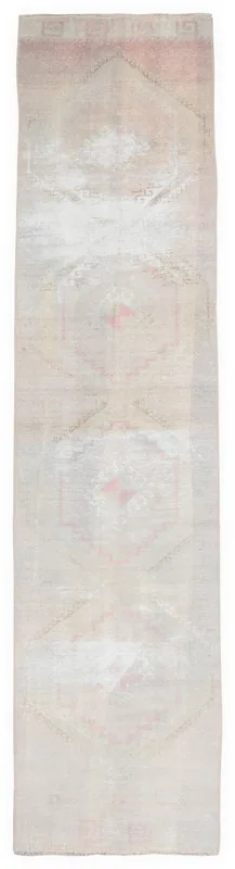 Full overhead view of the 2'8" x 12'10" soft rose and beige vintage Anatolian runner rug