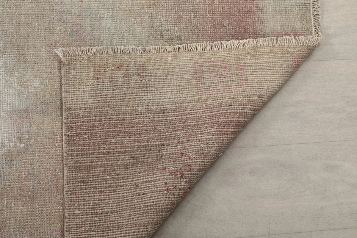 Full view of the rug's back, revealing the intricate hand-knotting on the cotton foundation