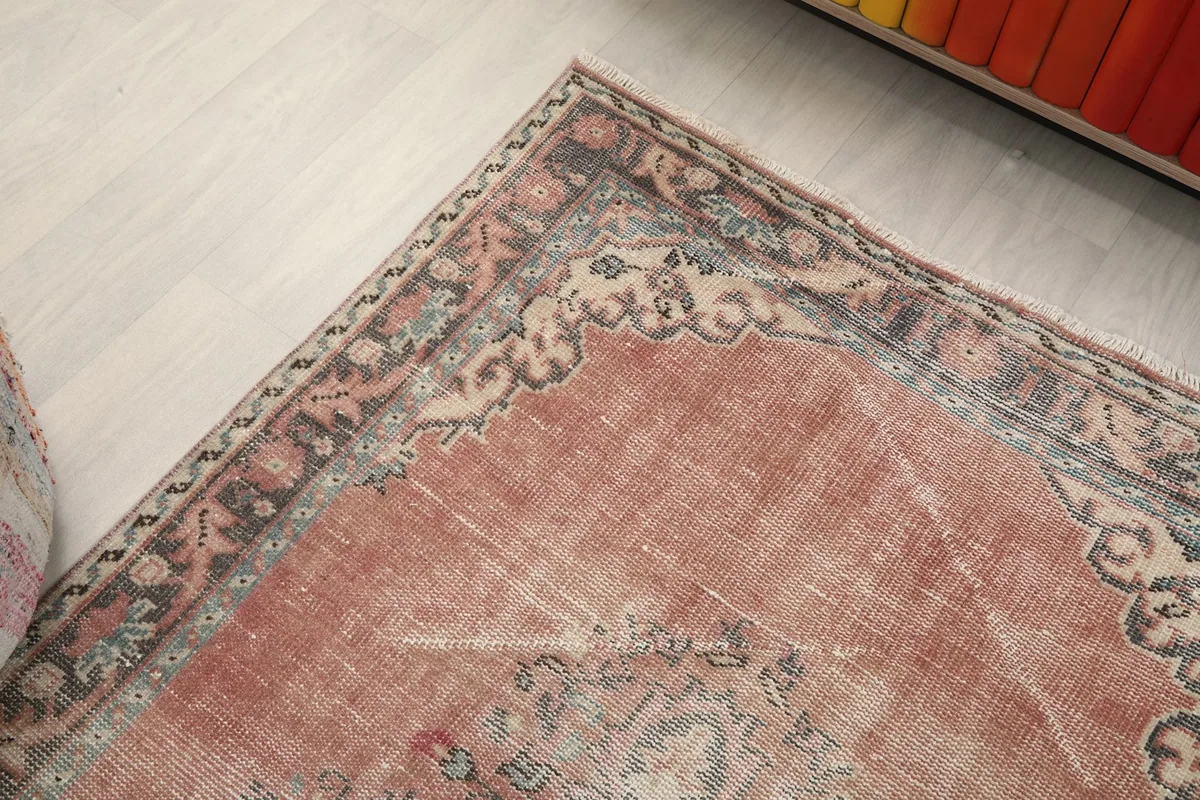 Corner view of the rug's border and field, capturing the subtle color variations.