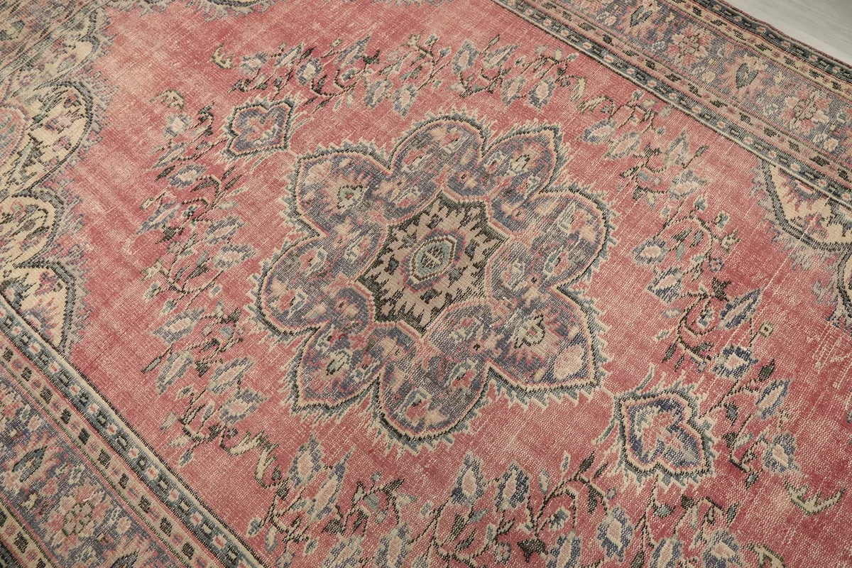 Close-up of the central medallion with faded rose and blue tones