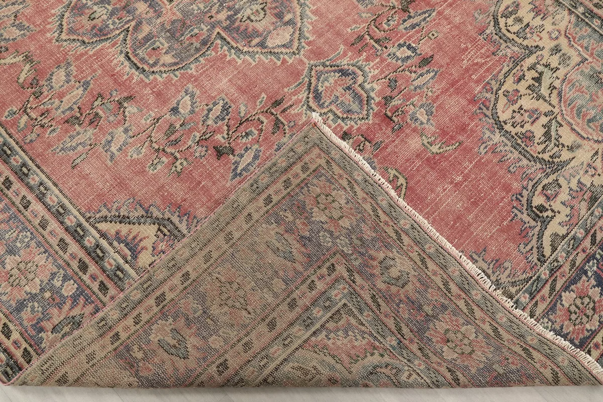 Underside view of the rug, showing the cotton foundation and knotting