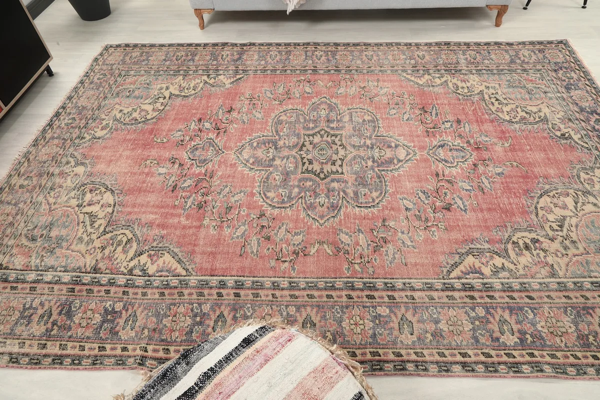 Overhead view of the vintage rose rug, showcasing its full pattern
