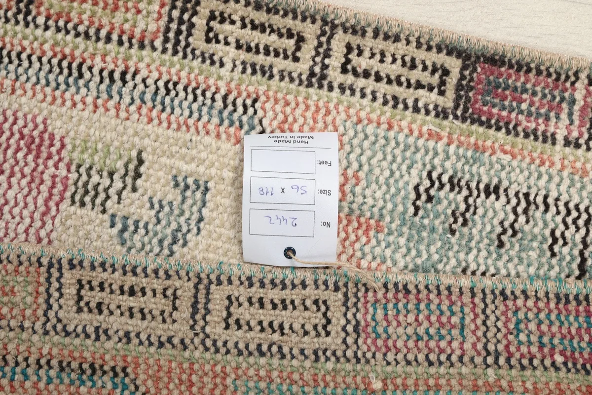 Close-up of the rug's texture and pattern with a size tag indicating dimensions.