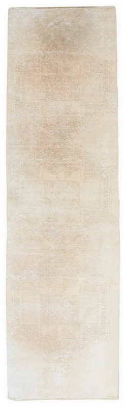 Full overhead view of the beige vintage Anatolian runner rug on a white background.