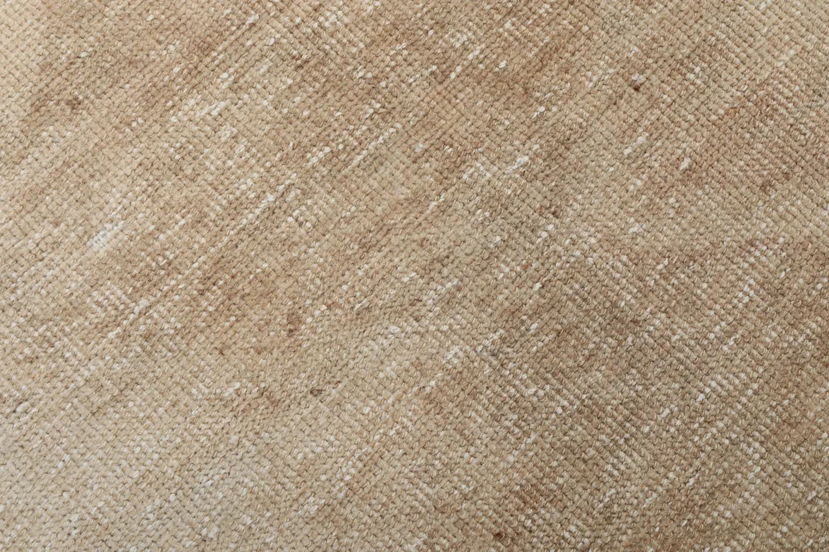Very close view of the hand-knotted wool pile, highlighting its vintage wear and texture.