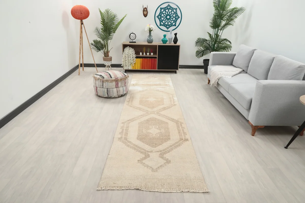 Vintage beige and brown runner rug laid out in a modern living space