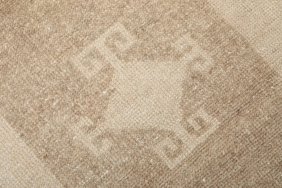 Texture of the low pile wool surface with brown geometric design