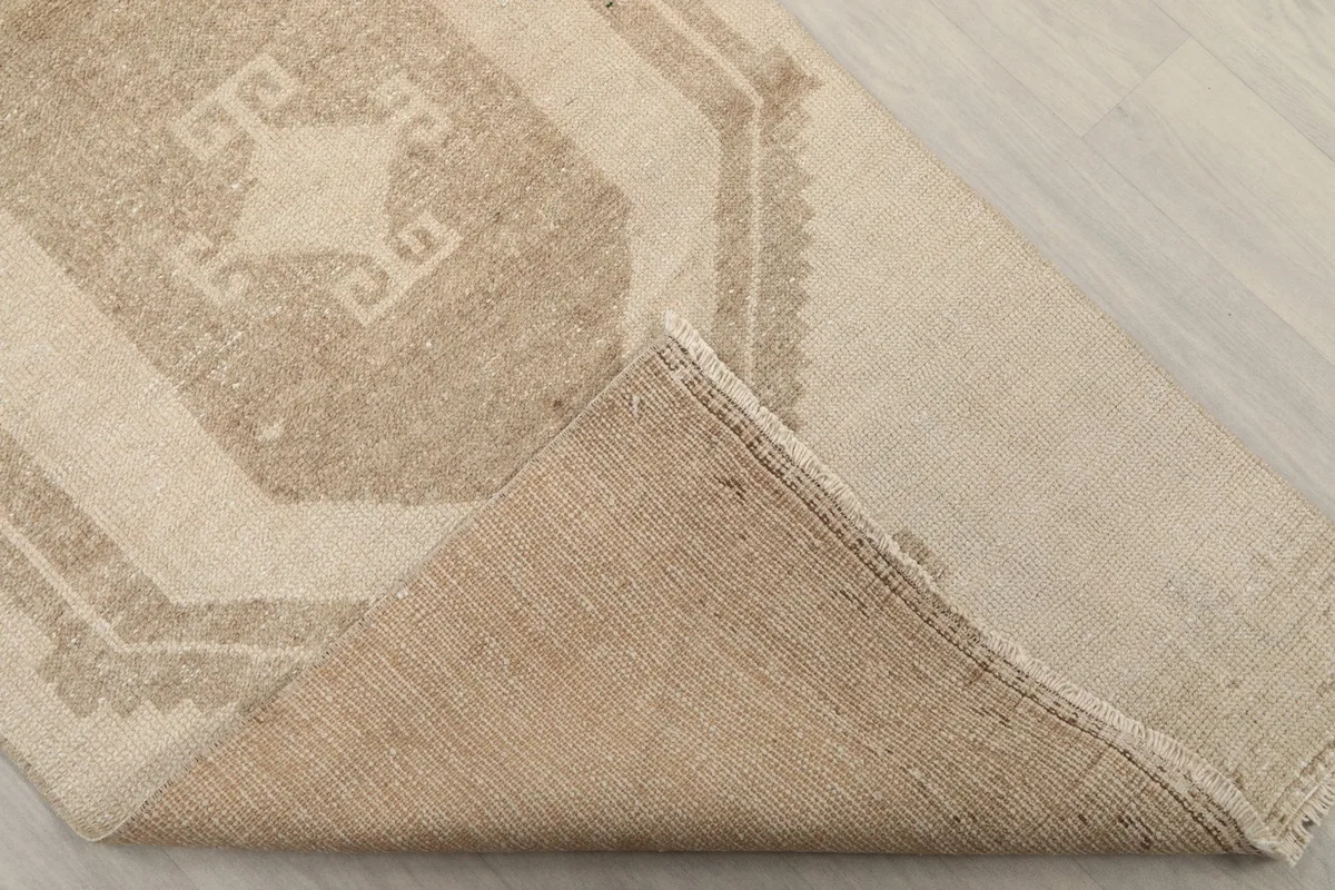 Underside of the hand-knotted runner rug, revealing the cotton foundation