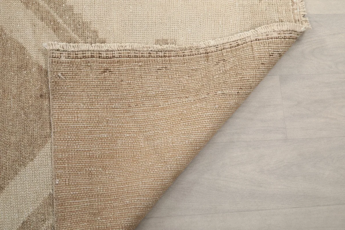 Close-up of the back of the runner rug, showing the wool knotting