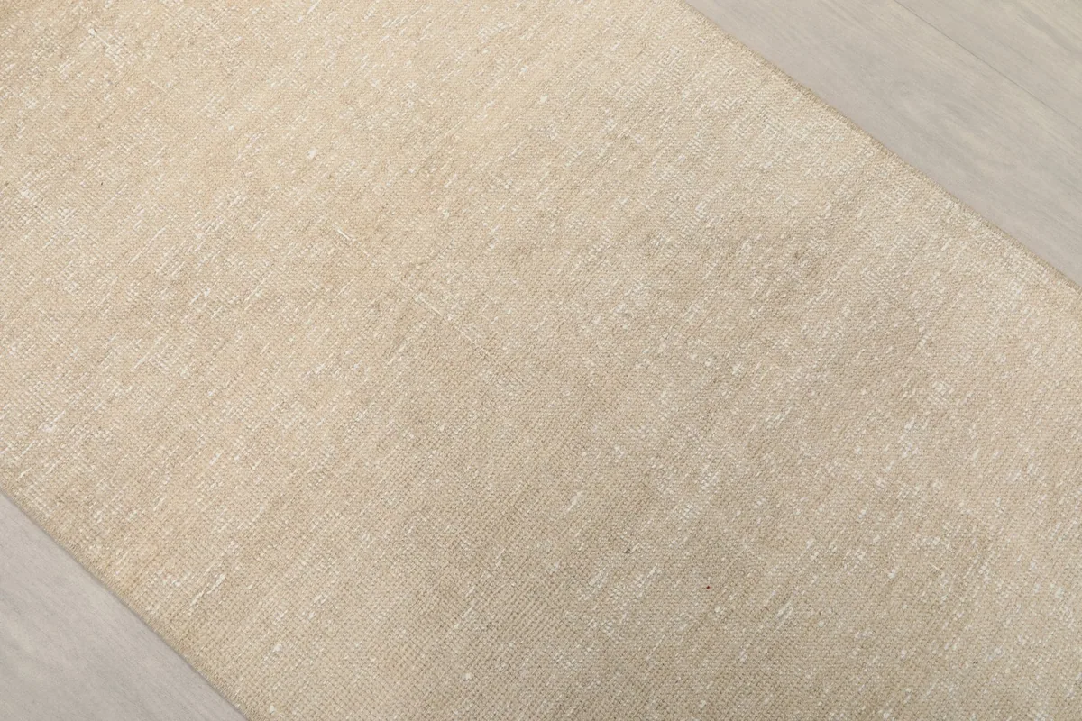 Angled view highlighting the vintage patina and natural variations in the beige runner