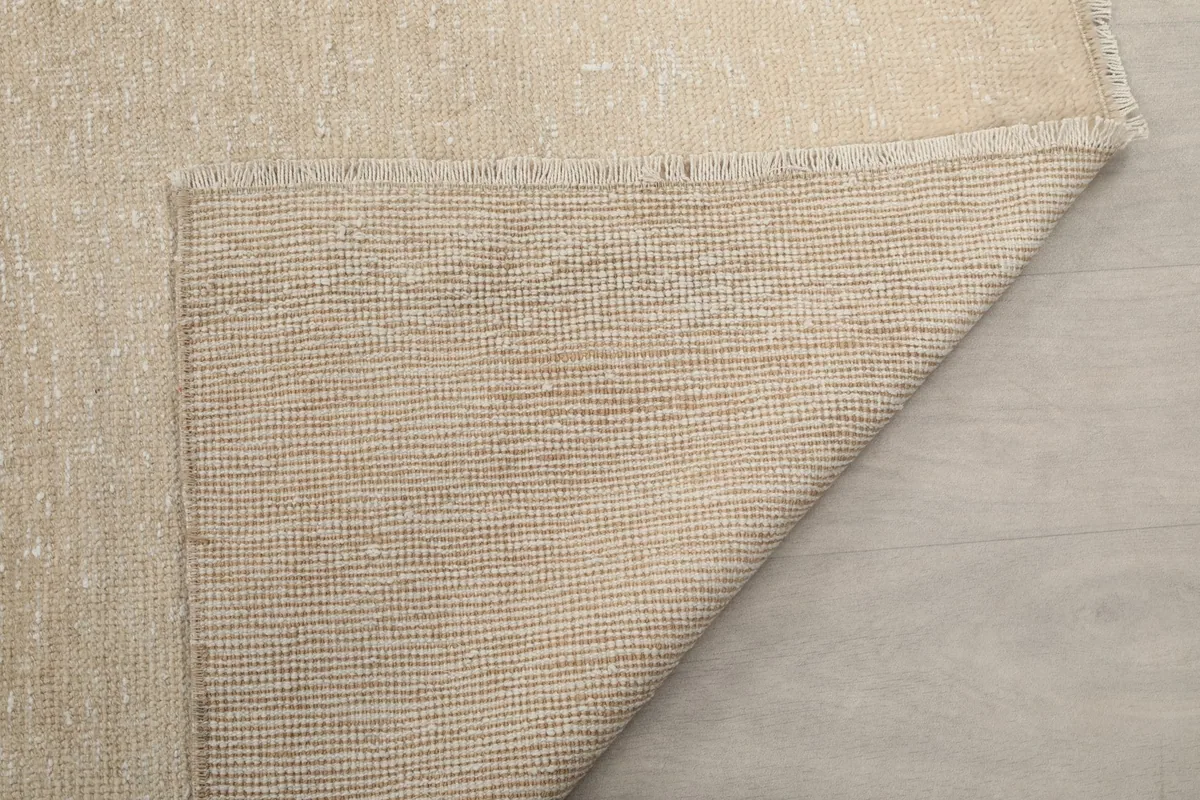 Corner view of the rug's back, revealing the intricate knotting and foundation