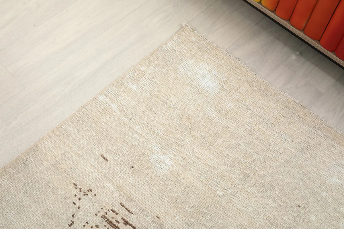 Angled view highlighting the subtle variations and patina on the rug's surface