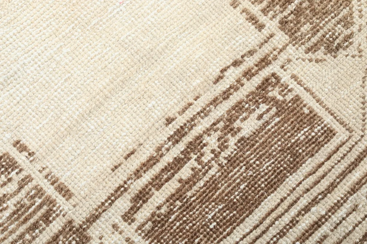 Texture and color detail of the hand-knotted wool pile and geometric design