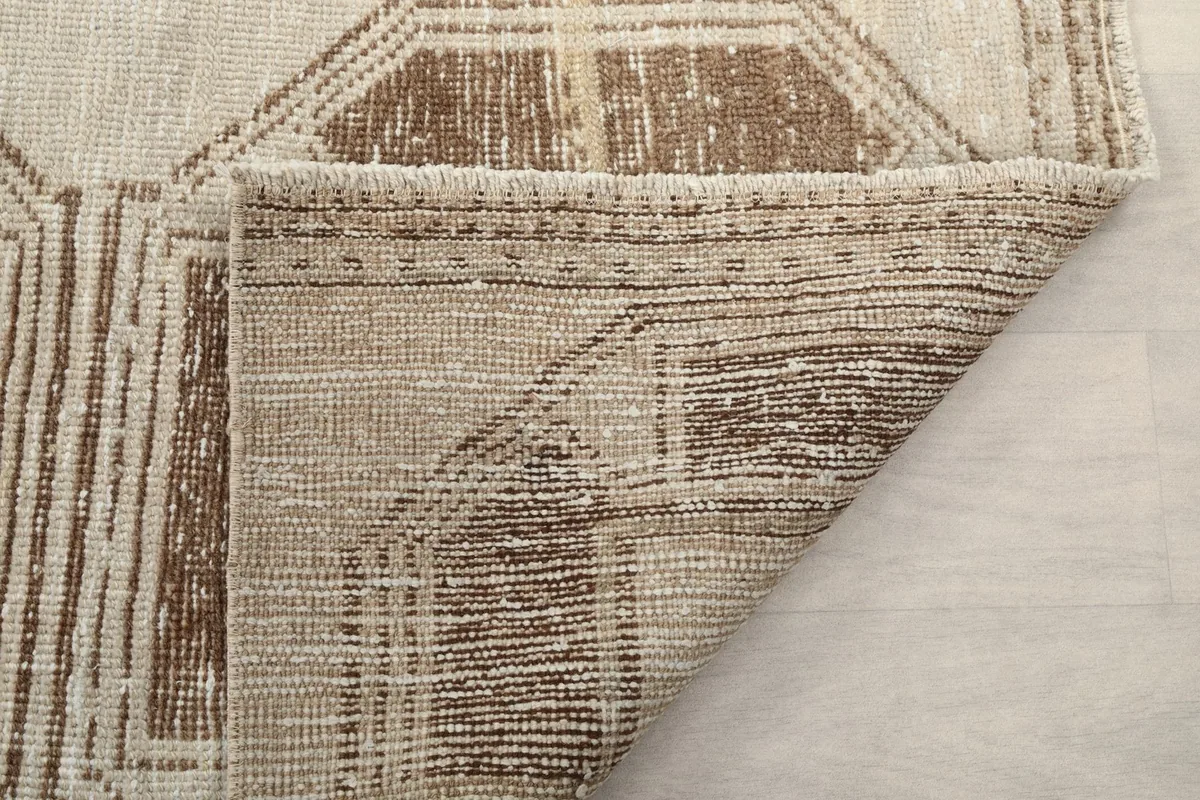 Underside view of the hand-knotted cotton foundation and back of the rug