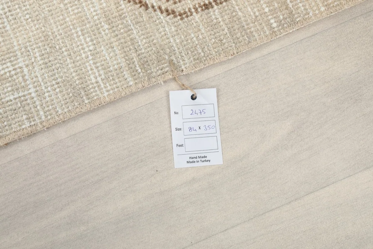 Product tag showing the dimensions and origin of the vintage Anatolian runner rug