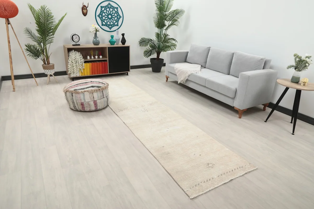 Angled view of the runner rug placed in a modern living space, highlighting its length and subtle pattern.