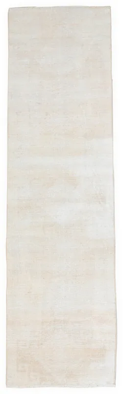 Full overhead view of the beige vintage Anatolian runner rug on a white background