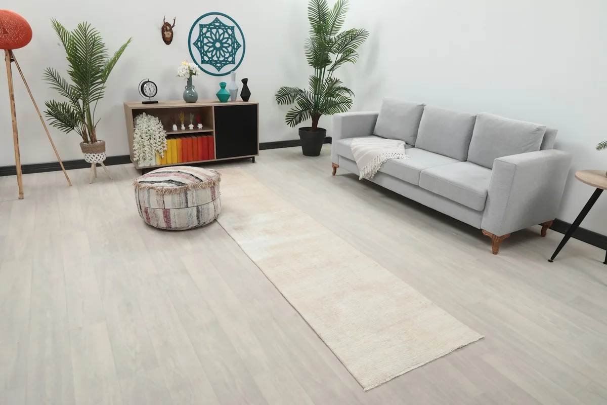 Angle view of the beige vintage runner rug in a contemporary room with light flooring