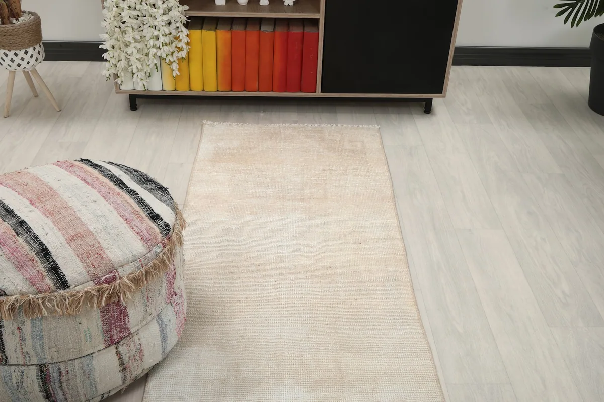 View of the runner rug extending into a room, with furniture in the background