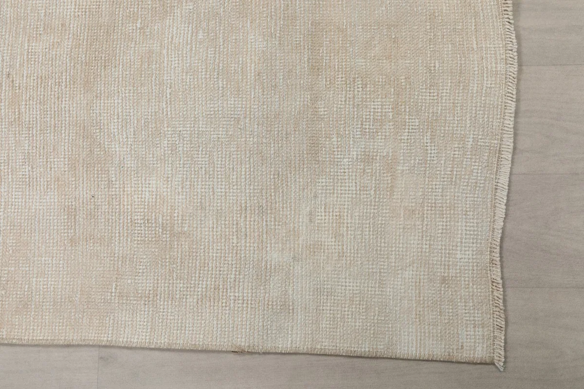 Overhead close-up of the rug's surface, highlighting the hand-knotted wool pile and weave