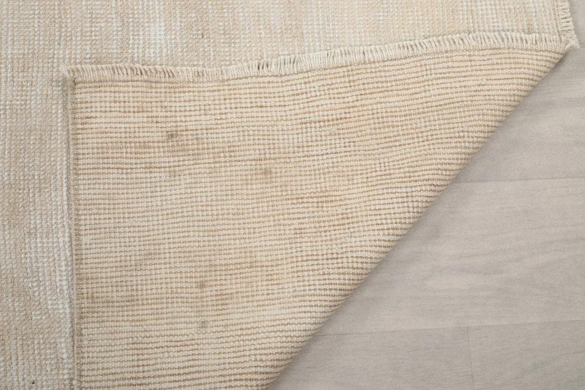 Close-up of the back of the rug, showing the durable cotton foundation weave