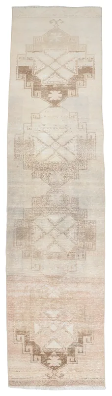 Full top view of the 2'10" x 13'5" ivory and brown geometric Anatolian runner rug on a white background