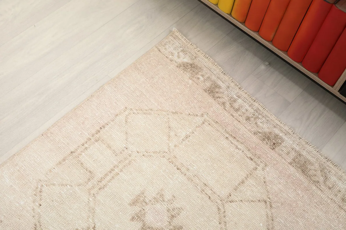 Corner detail of the rug showing the subtle border design and general patina