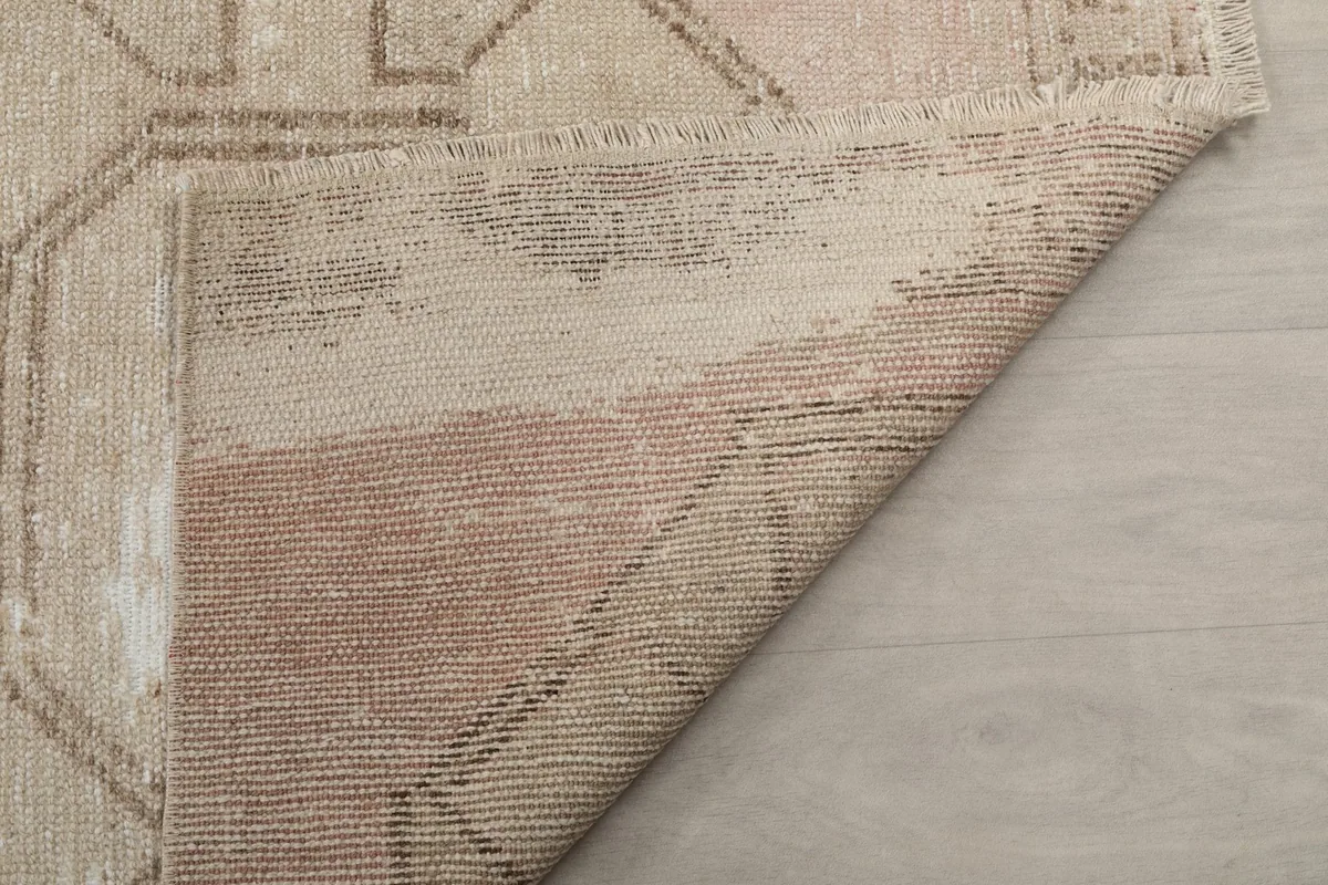 Underside of the rug showing the hand-knotted construction and cotton foundation