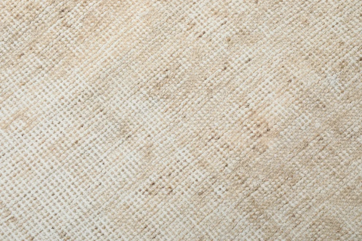 Macro shot of the low wool pile and visible weave of the hand-knotted vintage rug
