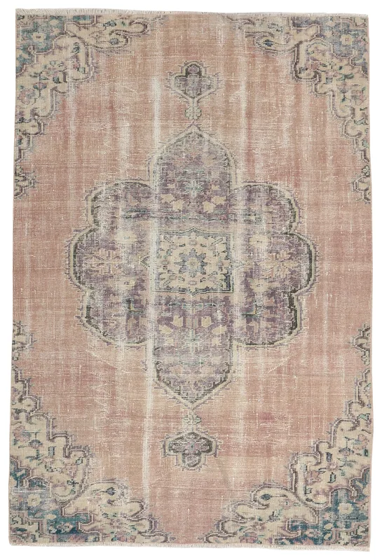 Full overhead view of the vintage rose and purple medallion rug