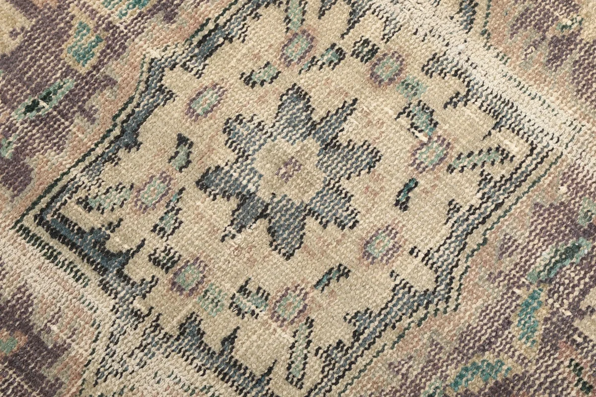 Intricate pattern detail within the medallion, showing beige and blue accents