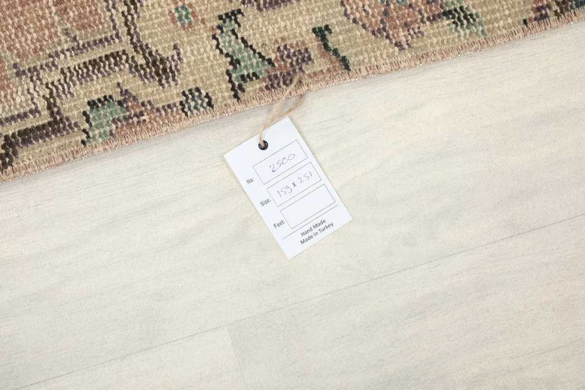 Tag showing the rug's origin, size, and material details on a light floor