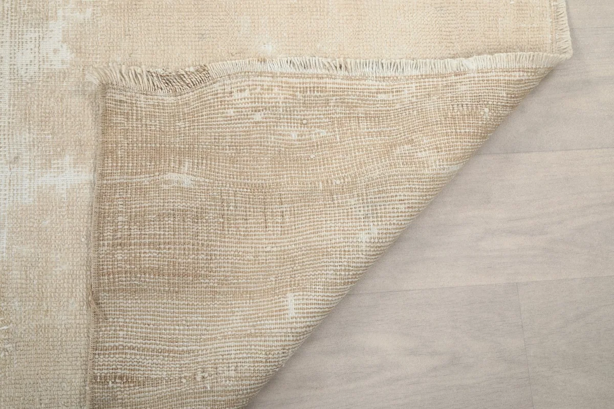 Another view of the rug's back, detailing the craftsmanship of the hand-knotted wool on cotton.