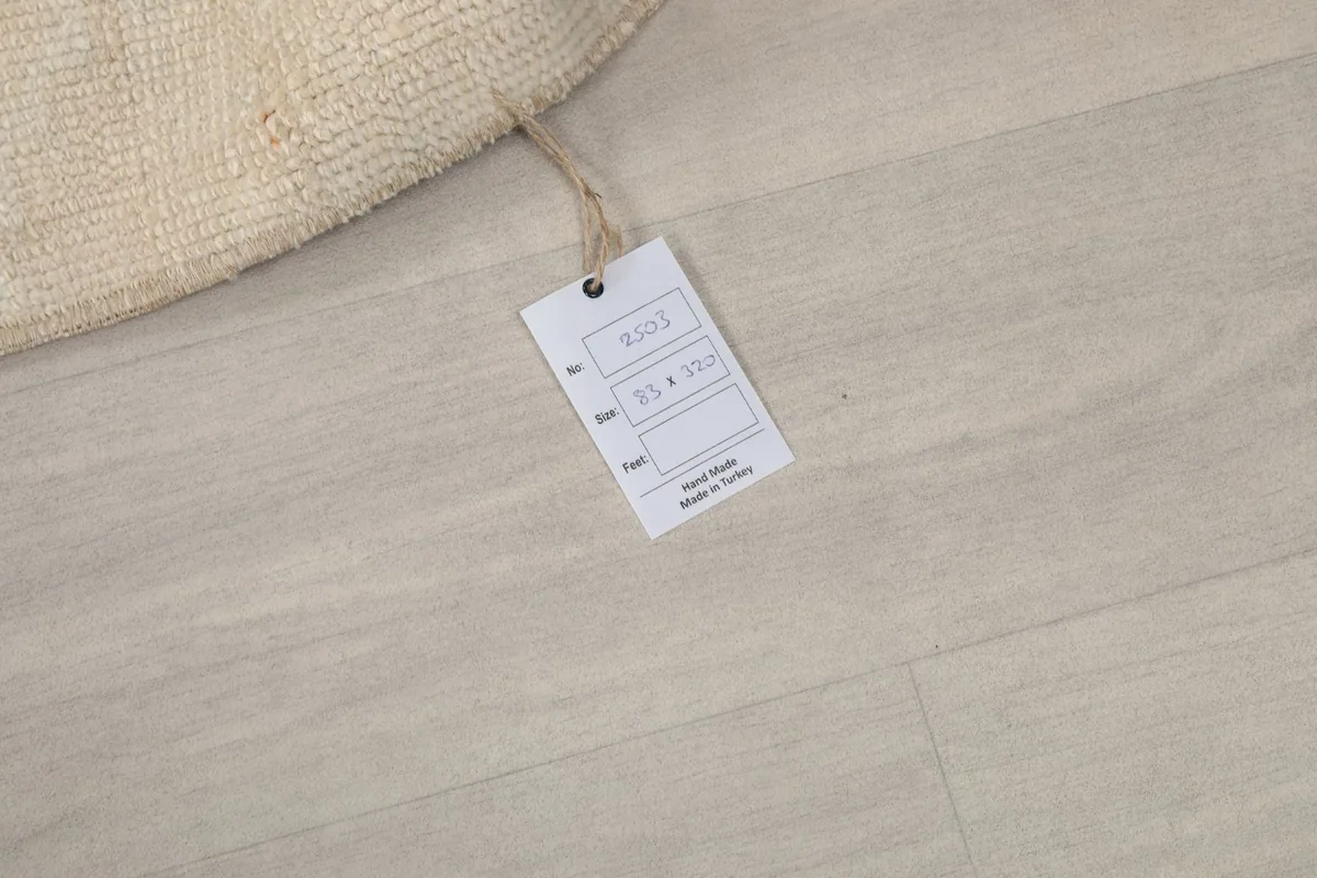 Product tag attached to the rug, displaying size information and its origin from Turkey.