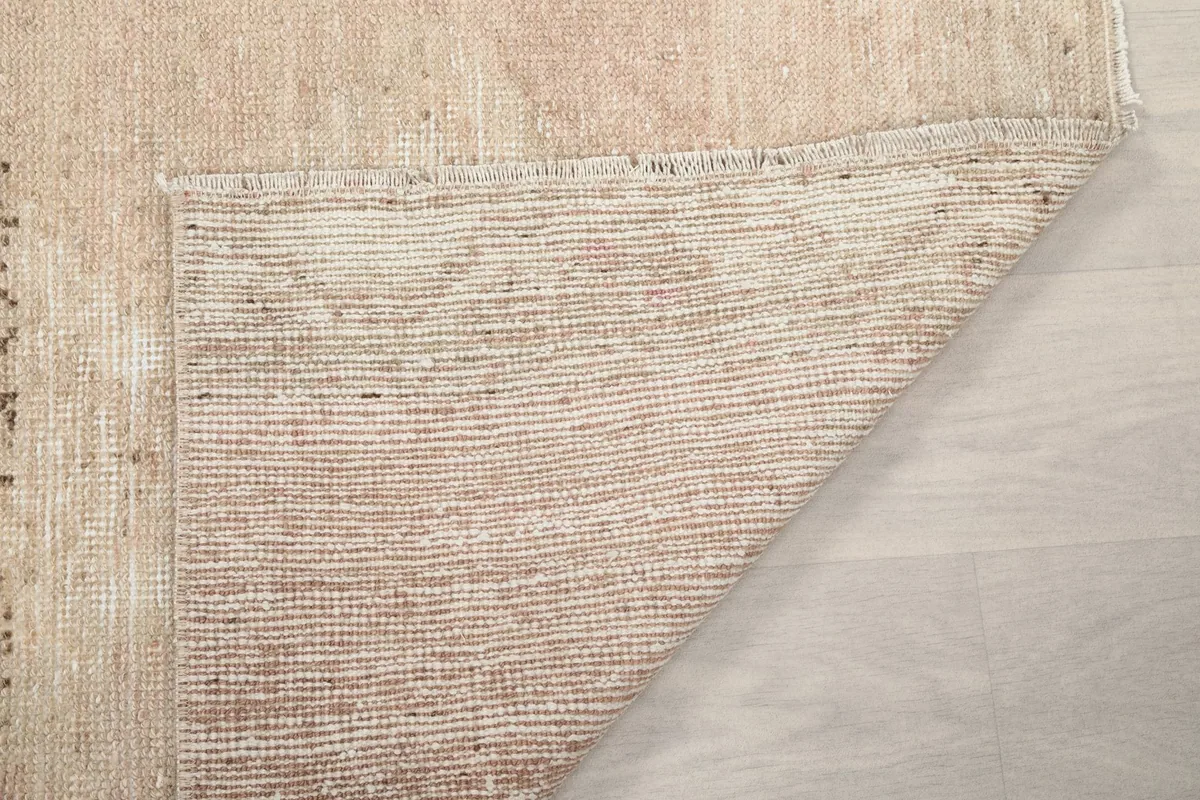 Detail of the rug's backside, showing the tight hand-knotted construction and cotton foundation.
