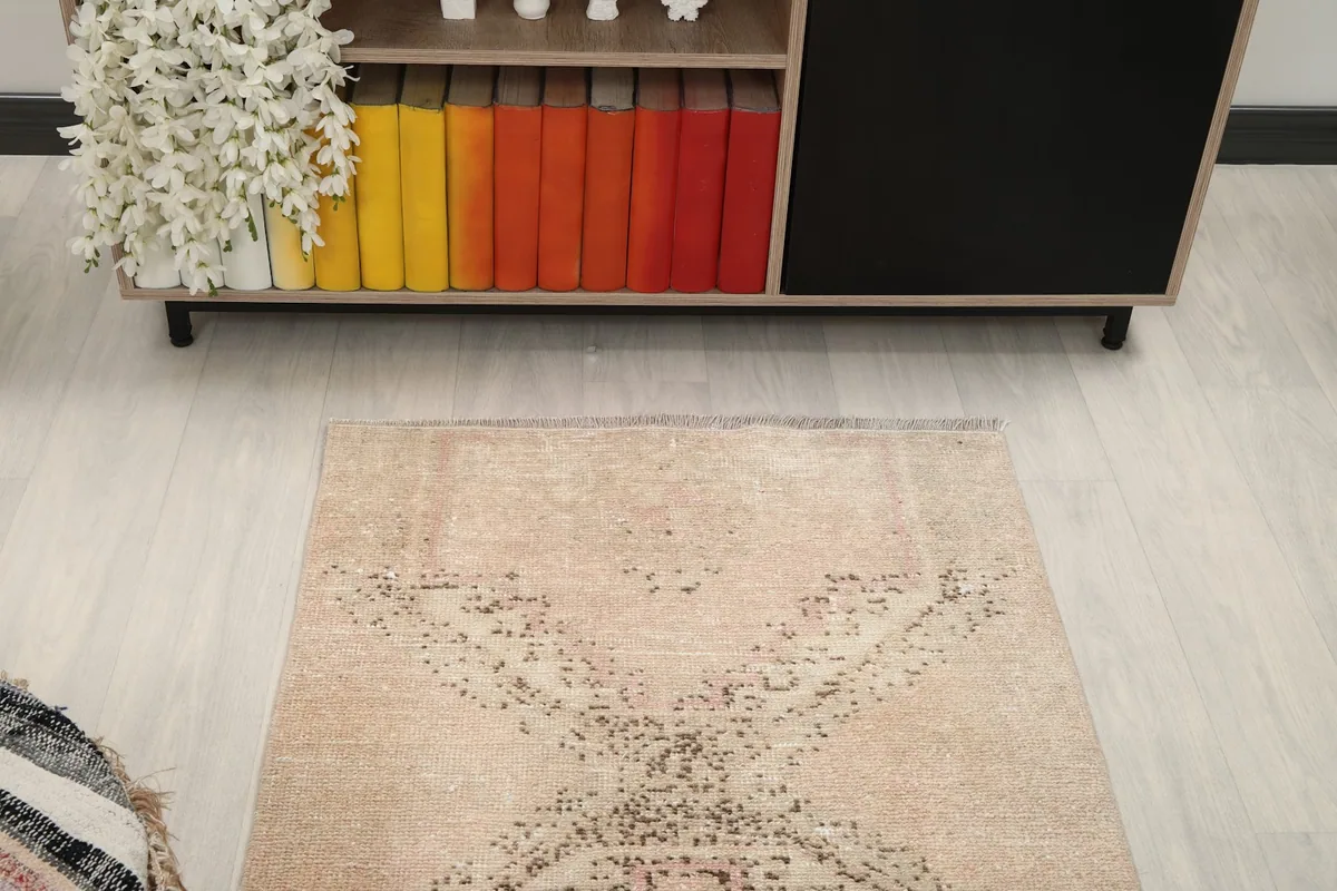 Overhead view showing the top portion of the rug and its patterns in a room setting.