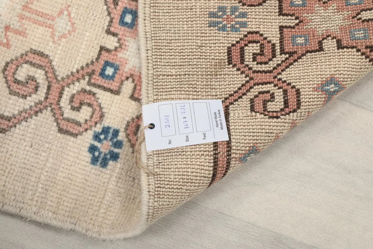 Close-up of the product tag attached to the back of the vintage hand-knotted Anatolian rug