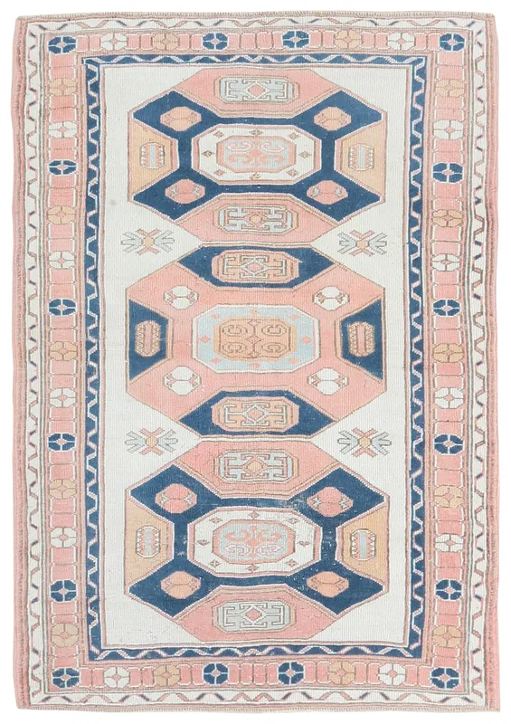 Full overhead view of the 4x6 ivory, rose, and navy vintage Anatolian rug on a white background