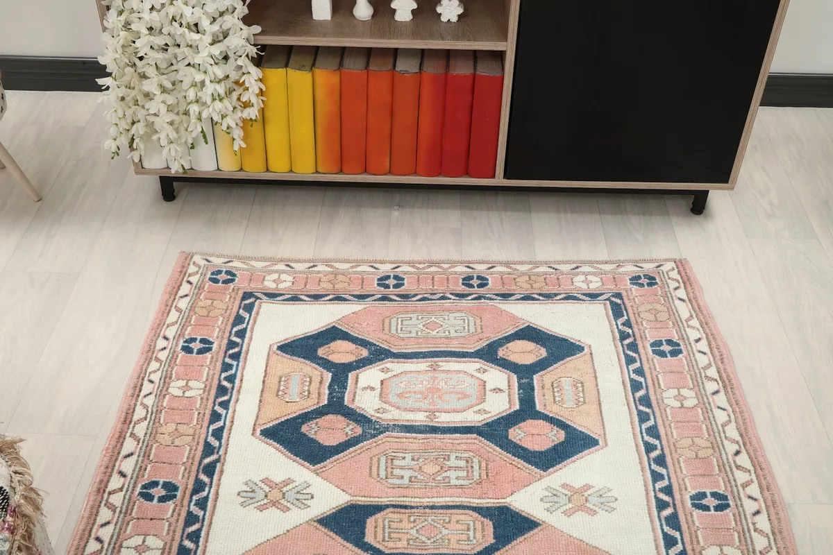 Overhead room view of the vintage rug, centered in a modern living space with light flooring