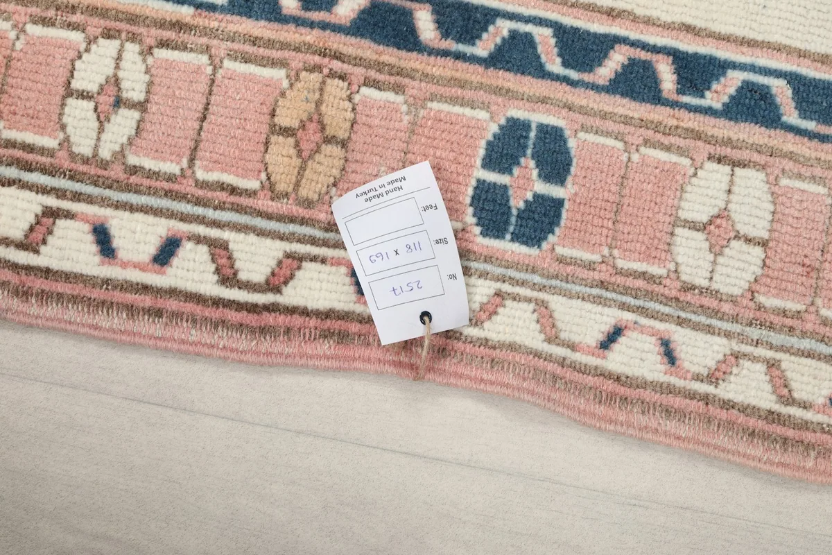 Close-up of the rug's edge, displaying the care tag with size and other rug details