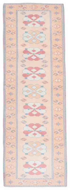 Full overhead view of the tan runner rug with rose and blue geometric patterns