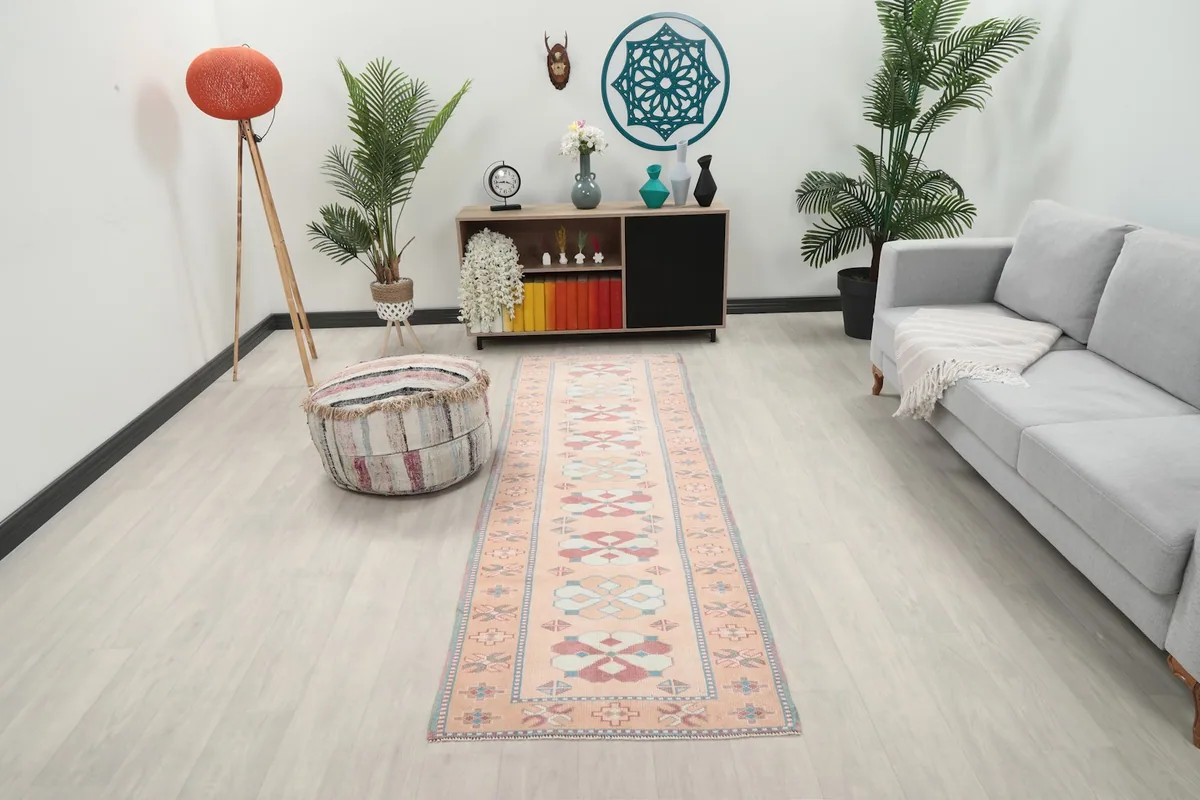 Runner rug displayed in a living room setting with a sofa and plants