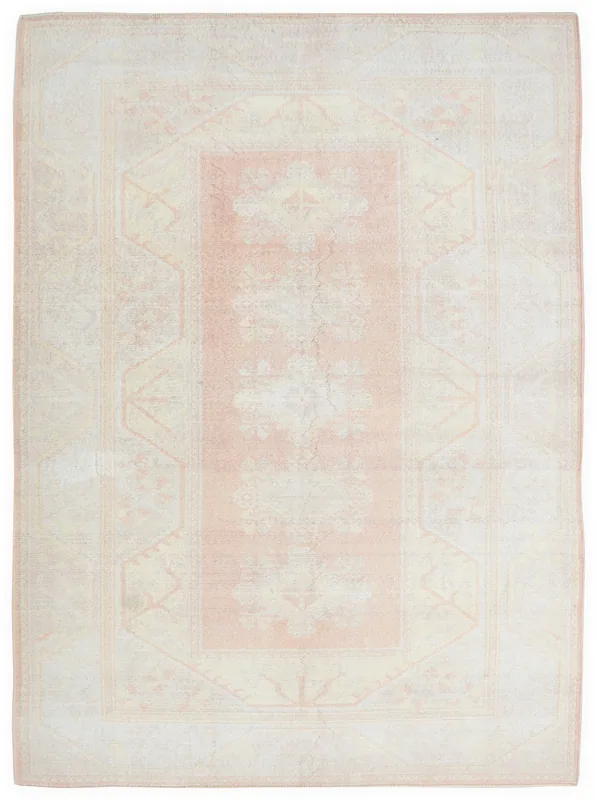 Full top view of a 6'7" x 9'7" rose and cream vintage Anatolian area rug on a white background.