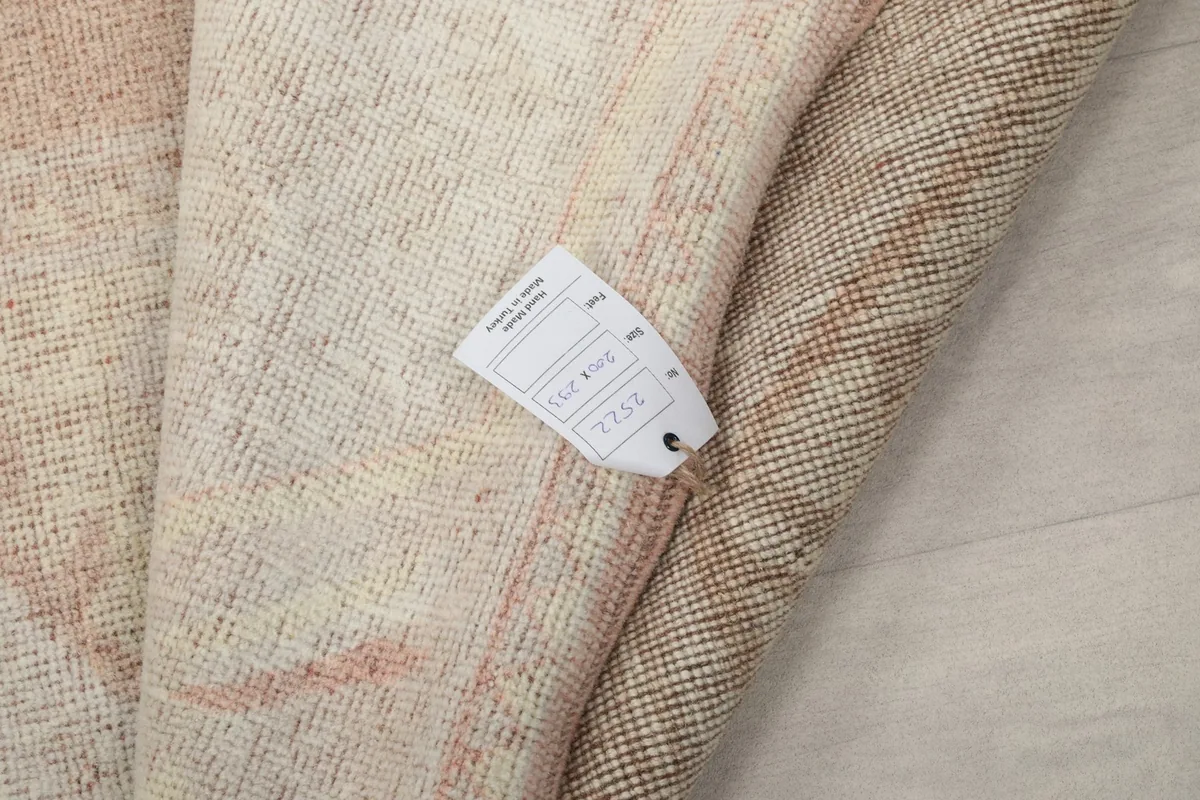Close-up of the rug's label, indicating its origin, material, and unique product number.