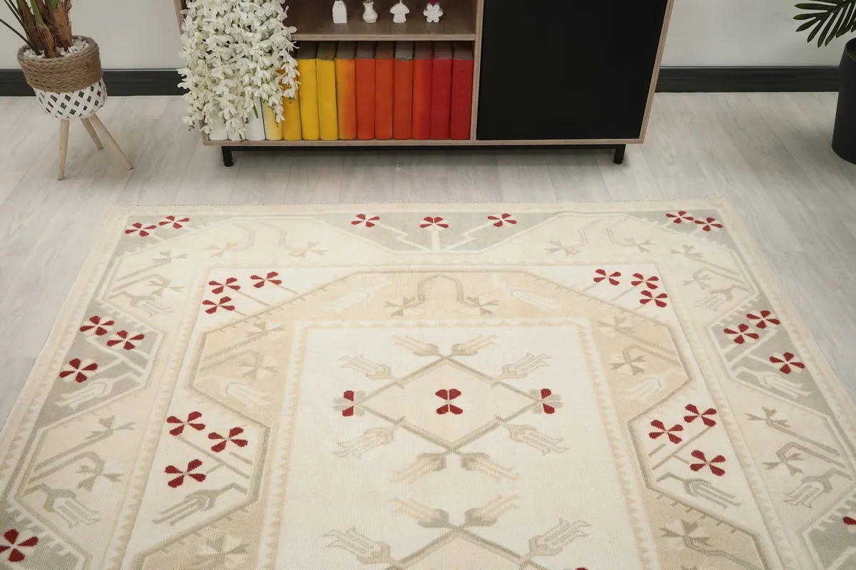 Overhead angle shot highlighting the rug's central design and surrounding border in a room setting.