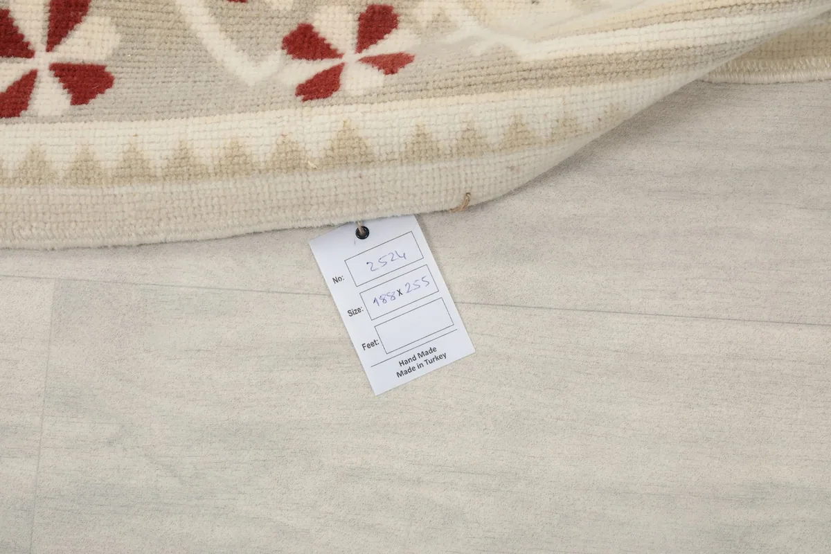 Close-up of the rug's label, indicating its origin and material details.