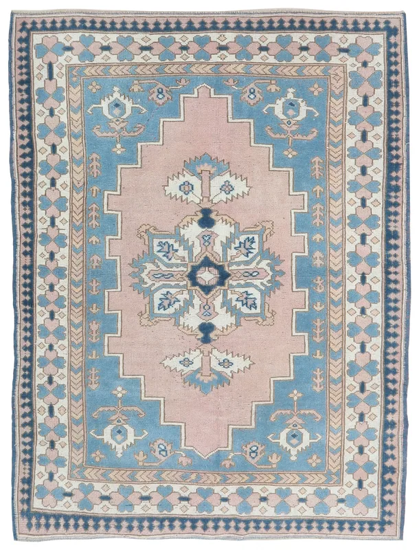 Full overhead view of the pink and blue vintage Anatolian rug